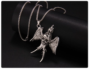 Close-up of punk style silver flying bird skull necklace with detailed feather textures