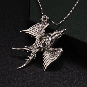 Gothic punk flying bird skull necklace with vintage silver finish and detailed feather wings