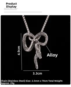Detail view of snake pendant in bow shape with dimensions 4.9cm by 3.3cm on black background