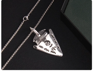 Macro view of silver Viking shield pendant and stainless steel box chain necklace