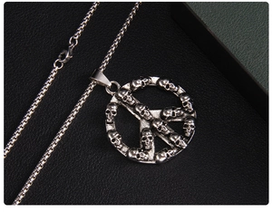 Macro detail of gothic peace sign pendant crafted from tiny silver skulls on black leather