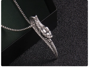 Gros plan du pendentif serpent argenté avec écailles détaillées sur chaîne box