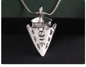 Macro detail of silver stainless steel Viking shield pendant with vintage tribal engravings