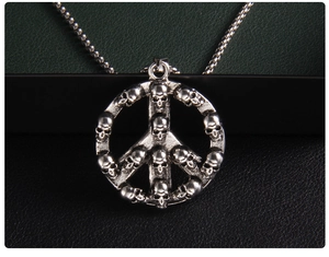 Macro view of peace sign pendant featuring detailed small skull head elements in retro silver