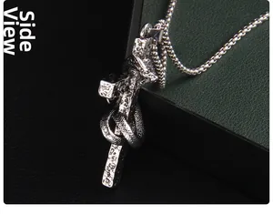 Side view of antique silver snake coiled around a gothic cross pendant necklace