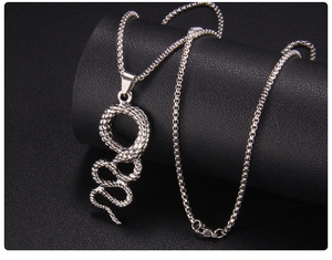 Detail of silver stainless steel snake pendant with scales and a durable box chain link