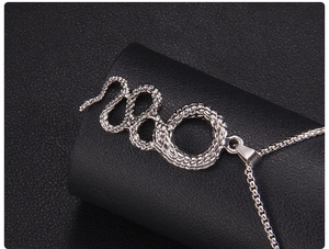 Macro view showing detailed snake scale texture and silver stainless steel pendant craftsmanship