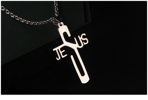 Close-up of polished stainless steel Jesus cross pendant with bright silver metallic finish