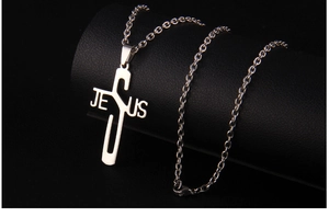 Macro shot of silver stainless steel JESUS letter cross pendant on O-chain necklace