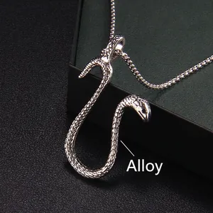Edgy silver snake pendant necklace with textured scales on a dark textured background