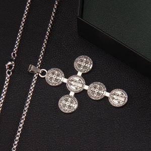 Vintage gothic Saint Benedict cross necklace with silver box chain on black background