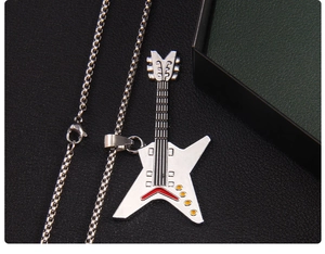 Detail of guitar pendant necklace with red and yellow enamel on a silver box chain