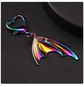Detail of gradient rainbow bat wing keychain with heart-shaped metal lobster clasp