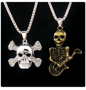 Close-up of gothic skeleton pendants with crystal rhinestones and guitar-playing skull detail