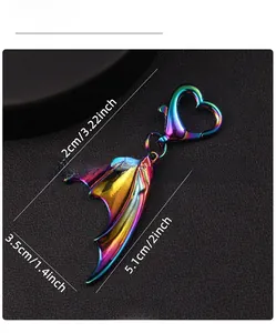 Macro detail of rainbow gradient dragon wing keychain with heart lobster clasp and dimensions