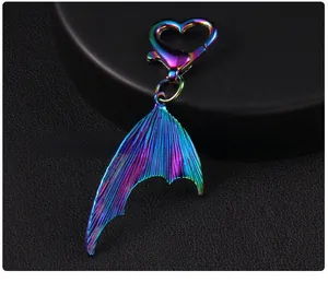 Detailed back view of a metallic gradient fish tail keychain with a heart shaped lobster clasp