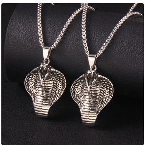 Detailed close-up of vintage silver cobra snake head pendant with intricate scale texture