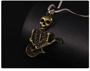 Macro view of vintage bronze skeleton guitarist pendant with detailed metal textures