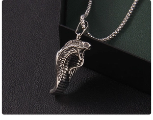 Macro view of cobra pendant showing detailed scales and textured punk style design