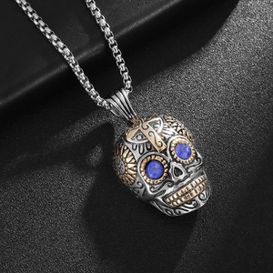Punk vintage stainless steel skull necklace with blue gem eyes and gold cross details