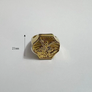 Detailed close-up of a 21mm gold hexagonal Saint Michael relief ring in stainless steel