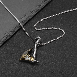 Gold-edged Viking axe pendant necklace with Valknut symbol on black stone background