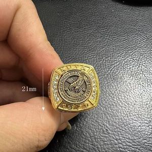 Macro detail of 21mm gold-plated eagle ring with 1979 engraving and CZ stone inlays