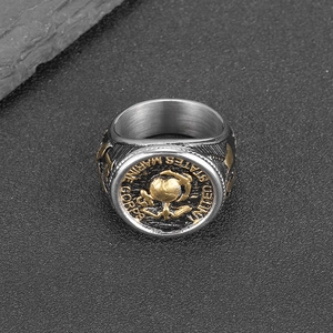 Polished stainless steel USMC eagle globe and anchor ring on grey rock background