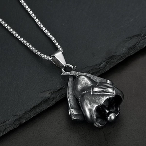 Gothic stainless steel grim reaper bell pendant necklace with scythe on stone surface