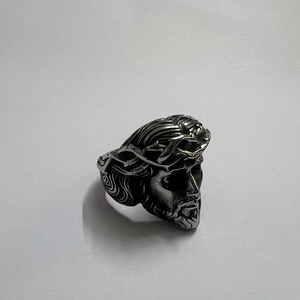 Close-up of a silver stainless steel ring featuring a detailed Jesus portrait design