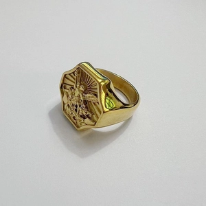 Detailed macro view of St. Michael archangel engraving on golden stainless steel signet ring
