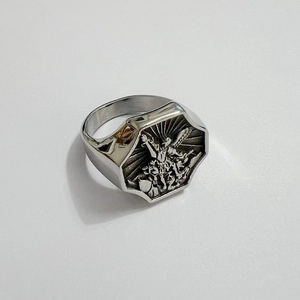 Detailed relief of Saint Michael fighting dragon on vintage stainless steel ring