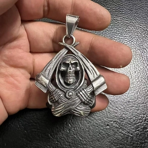 Detailed view of grim reaper pendant with crossed scythes and 925 silver engraving