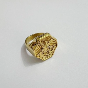 Macro view of octagonal gold ring with embossed Archangel Michael fighting the dragon