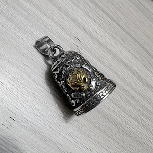 Macro shot of stainless steel biker guardian bell with gold skull and relief engraving