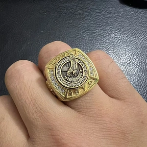 Macro shot of gold-plated Philippine Eagles men's ring with 1979 engraving and rhinestones