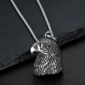 Polished stainless steel eagle bell pendant on a ball chain with a vintage finish
