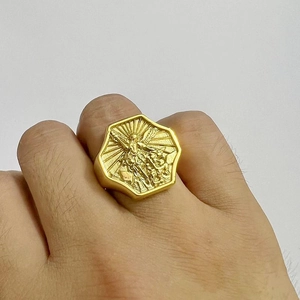 Detail of a men's vintage gold signet ring featuring a Saint Michael relief engraving