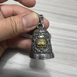 Macro detail of a vintage bicolour motorcycle guardian bell with a skull relief design