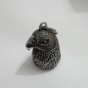 Detailed close-up of retro stainless steel eagle biker bell with vintage relief textures
