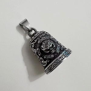 Detailed view of stainless steel skull guardian bell with vintage chain texture and engraving