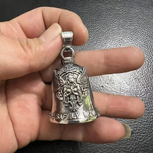 Macro shot of stainless steel biker bell pendant with angel relief and LIVE SAFELY engraving