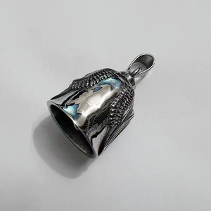 Close-up of vintage stainless steel guardian bell with detailed eagle wing engraving