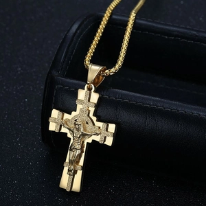 Gold vintage Jesus crucifix cross necklace with box chain over black jewelry box
