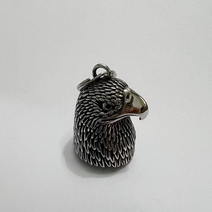 Macro shot of retro stainless steel eagle bell featuring intricate feather texture details