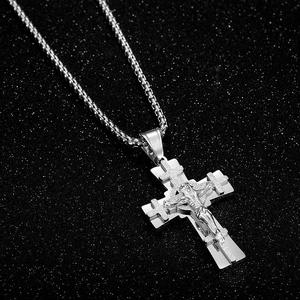 Detail of layered stainless steel cross necklace with polished and sandblasted finish