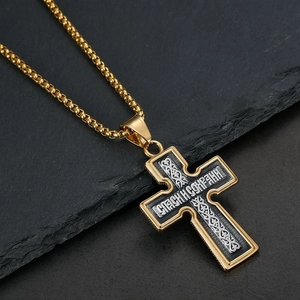 Retro stainless steel Orthodox cross pendant necklace on a black slate background