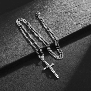 Polished stainless steel crucifix pendant on Cuban chain necklace for a punk hip-hop look
