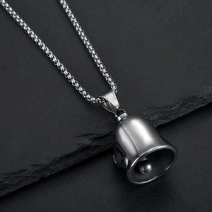 Polished stainless steel motorcycle guardian bell pendant with box chain on black rock