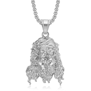 Detailed close-up of silver Jesus portrait pendant with thick link chain and textures
